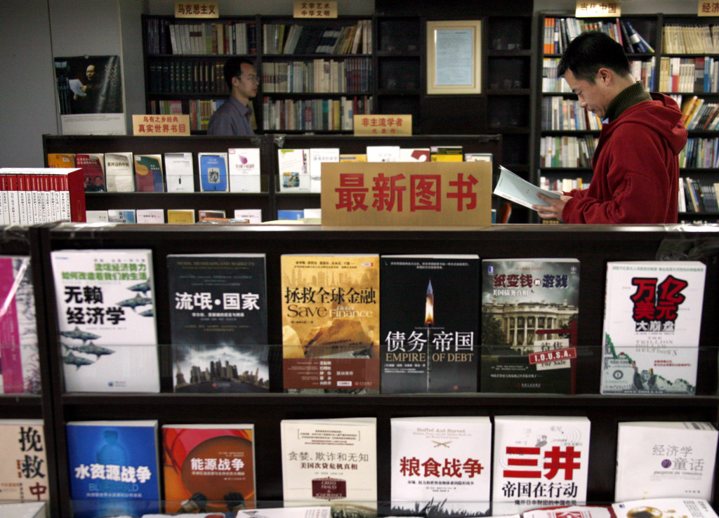 A man reads a book at the Utopia bookshop in Beijing