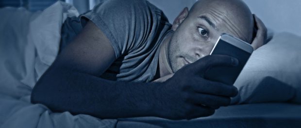 internet-addict-man-awake-at-night-in-bed-with-mobile-phone