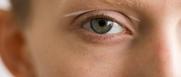 Intense close-up of an eye with a streak of white makeup